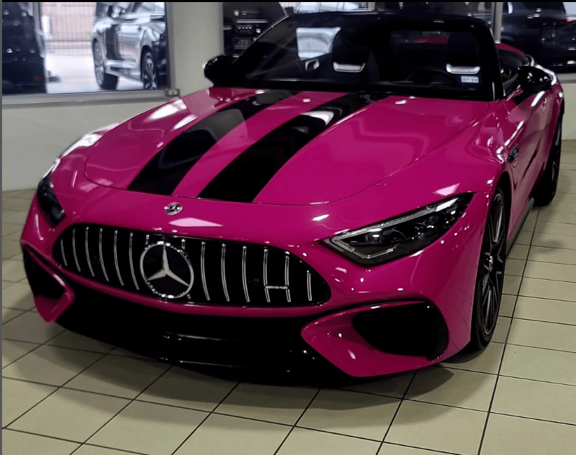 Pink Mercedes AMG sports car inside Houston auto body showroom