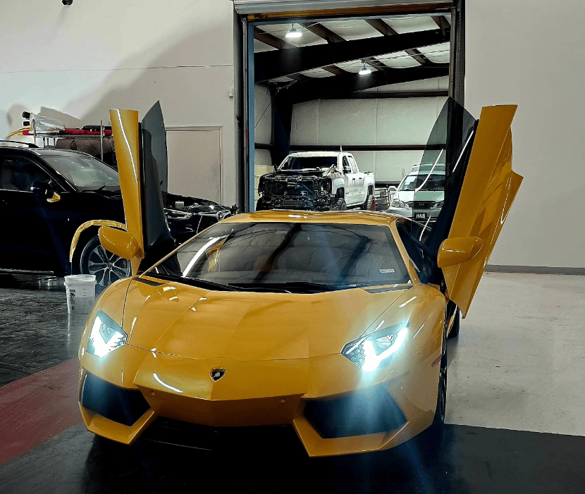 Yellow Lamborghini inside modern Houston collision center