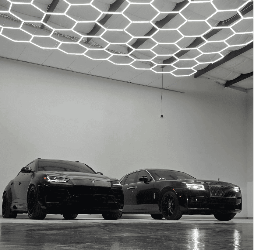 Lamborghini Urus and Rolls Royce inside premium Houston repair facility